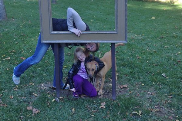 Mom, daughter and dog with picture frame